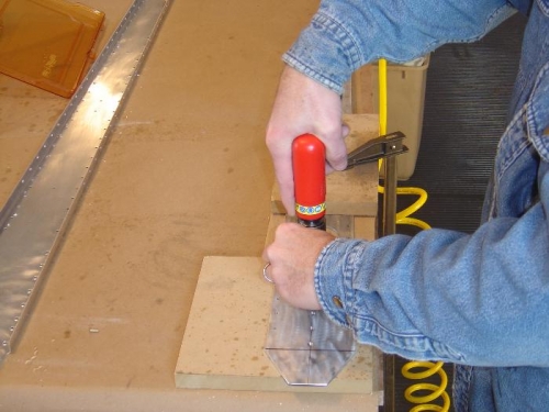 Countersinking the rivet holes in the bottom of the rear spar reinforcement (cordless drill was dead)