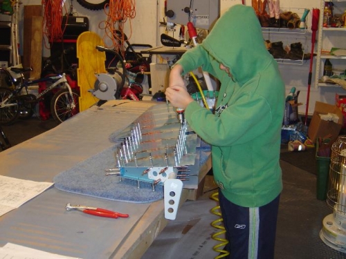 Mitchel is match-drilling the skins to the understructure per the plans.