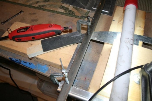 Here you can see my steel bar clamped along one of the edges for trimming to final size