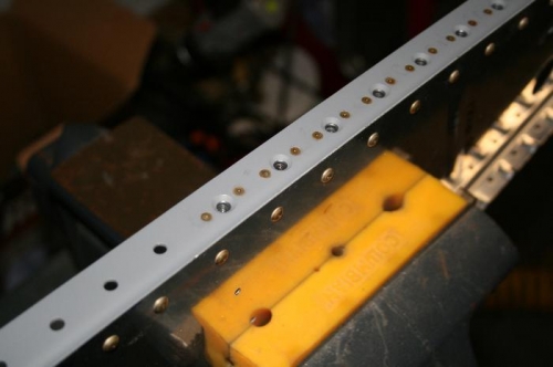 Nutplates riveted onto the one of the angles.