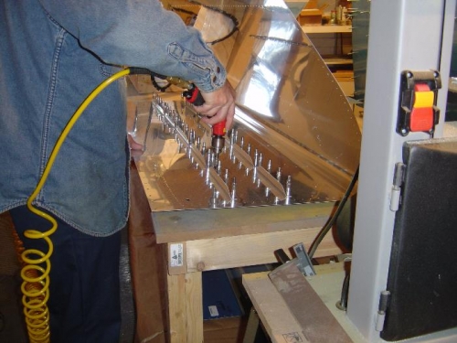 Match-drilling the stiffners that go on the bottom of the fuel tank skin.