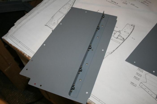 Nutplates are on the attach angle and the angle is riveted to the mid-cabin cover