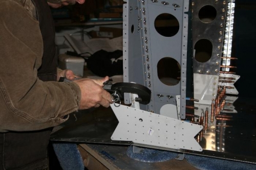 Squeezing the rivets that attach the weldment (light gray) to the gear tower.