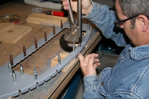 Riveting the doubler to the bulkhead.
