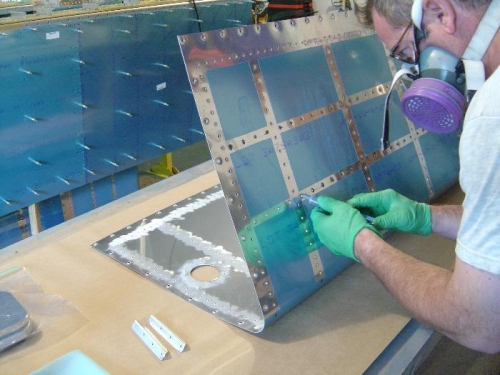 Using a syringe to dab sealant into each dimple