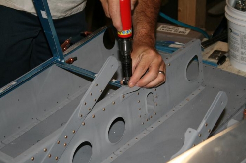 Countersinking the flush rivet that attached the floor support angle.