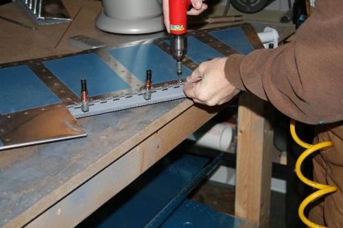 Match drilling the elevator skin and the trim tab hinge.