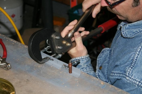 Riveting the nutplates onto the aft floor support - cleco'ing to the bench works good.