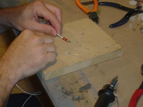 Soldering a terminal on the end of one of the fuel sender wires.
