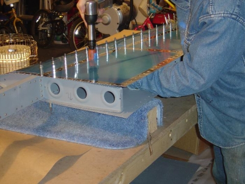 Riveting the bottom skin to the front spar and center rib