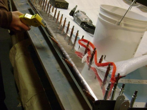 Riveting the counterbalance to the skin using blind rivets.