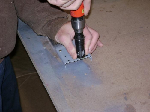 Countersinking the aileron end rib rivet holes.