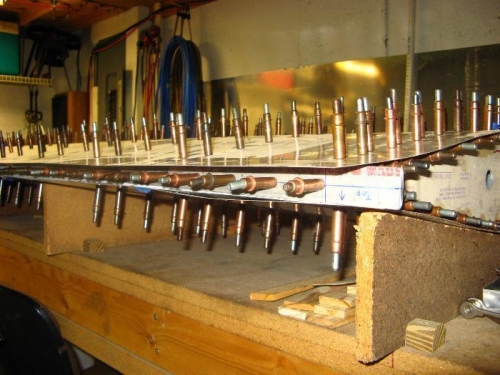 Fastened to rear spar