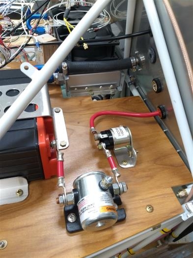 Shelf with starter solenoid and cable