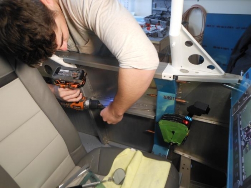 Parker drilling out the old armrest rivets.