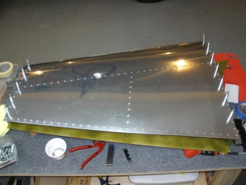 Riveting the skin to the understructure.