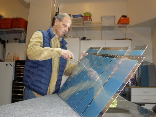 Deburring rivet holes on the rudder skin.