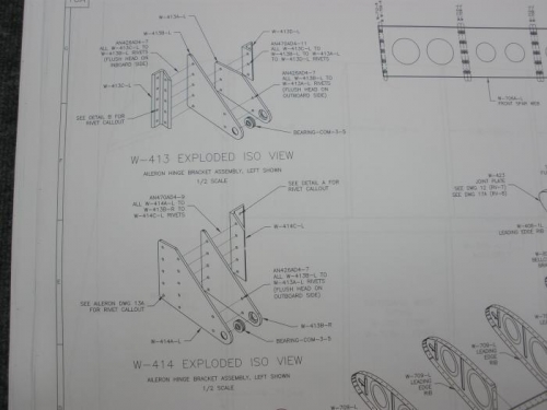 Studying plans for aileron bracket assembly.