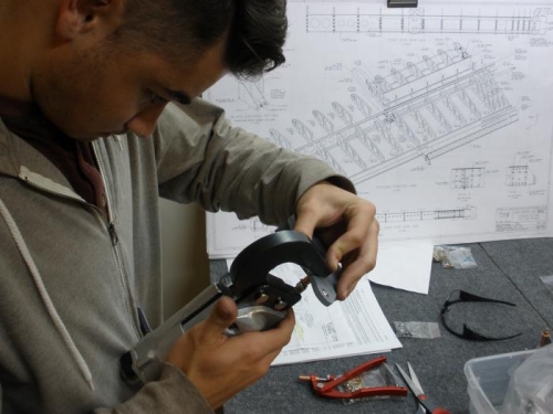 Riveting the Aileron Brackets together.