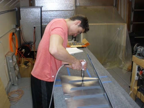 Back riveting the stiffeners to the elevator skin.