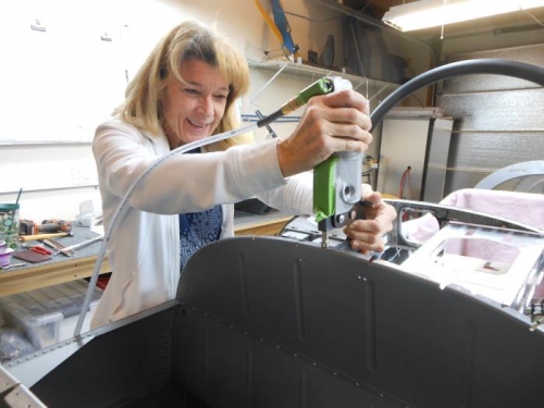 Terri dimpling the forward baggage bulkhead flange.