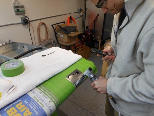 Using a nibbler to rough cut the hole.