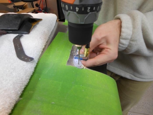 Drilling the lense retaining strips to wing.