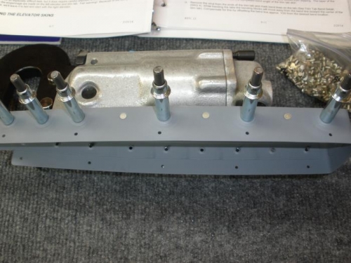 Riveting couterweight skin to upper rudder rib.