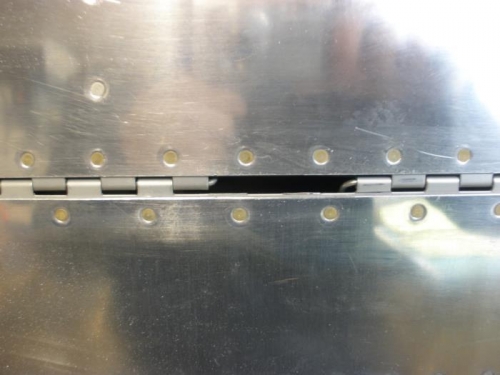 Flap hinge pin cut into two pieces.