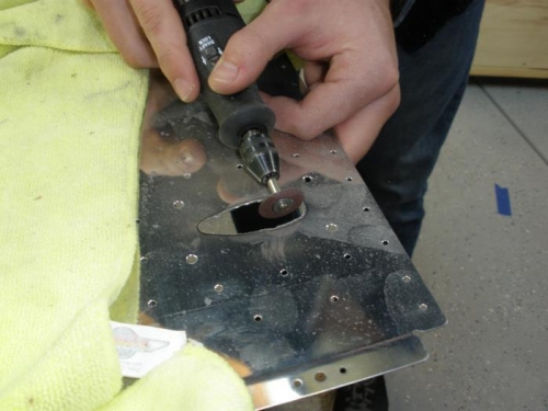 Cutting hole for pitot tube mast in wing skin.