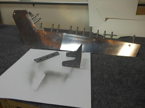 Support brackets primed, right armrest assembled.