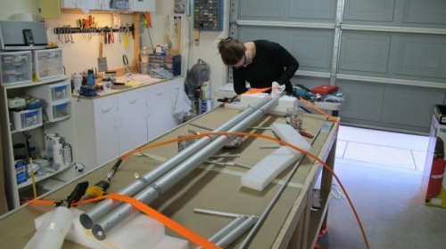 Justine works on ailerons. Tie downs allowed spars to roll on axis aiding construction.