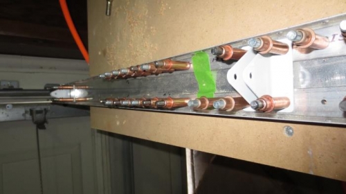 Elevator brackets match drilled to spar