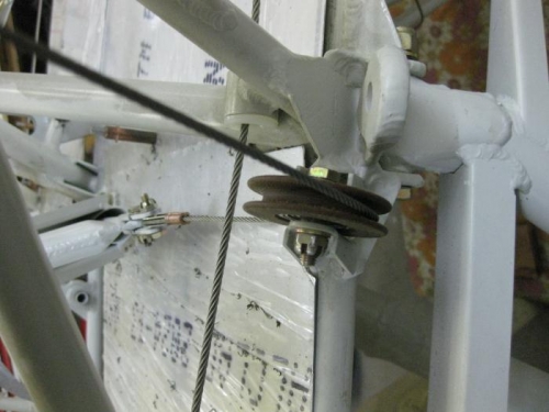Check alignment with aileron pulley and bolt assembly through floor board to airframe