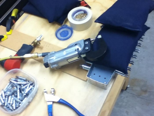 Braced with wood to push against and weighted with sand bags