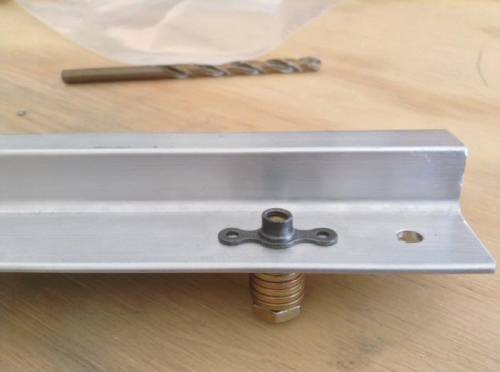 Bolt and washers holding plate nut in place for drilling