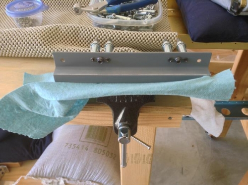 Riveting nut plates to tie down