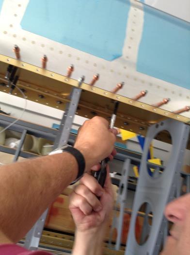 installing bolts through spar to tank bracket
