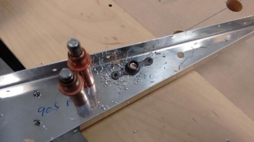 Nut plate rivet holes drilled