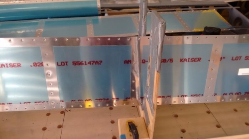 Aileron forms holding up skin for dimpling