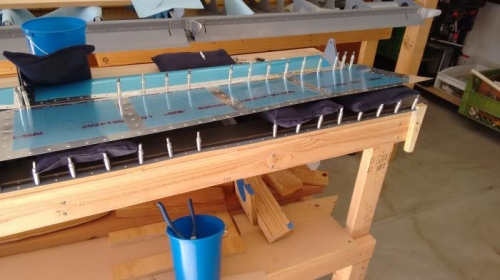 Reaching in and under to buck rivets