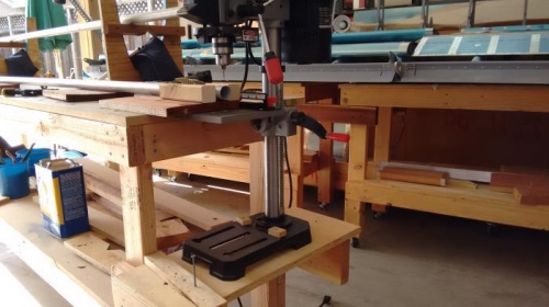 Shelf to lower drill press