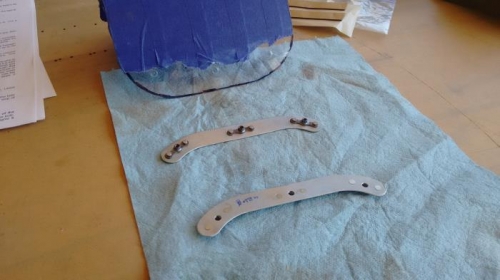 Retaining bracket with nut plates installed.