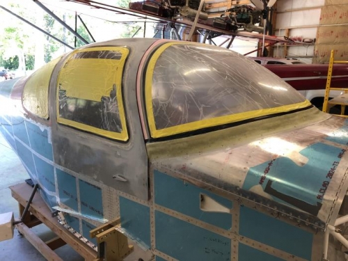 final layer of fiberglass layup.  Fitting the door better.  Smoothin around all transparencies