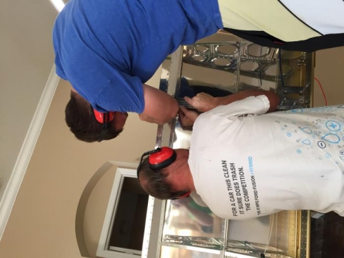 Riveting L wing gap seal.  Jimmy and Jordan working together