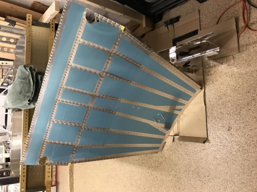 FWD floor stiffeners riveted to bottom skin