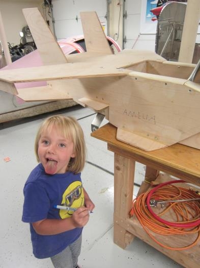 Amelia signs her name.