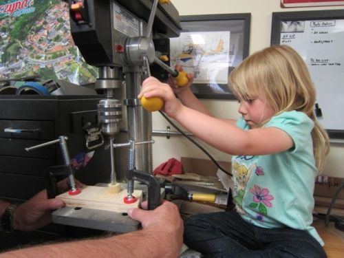 Amelia using the drill press.