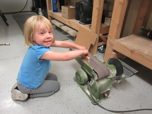 Amelia, learning to use the belt sander