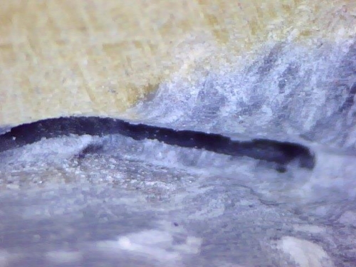 Microscopic photo of origonal epoxy job. MIssing good bond. What a gap!
